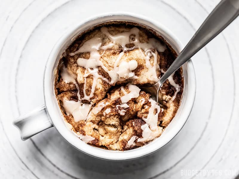 Overhead view of a spoon dug into a Cinnamon Nut Swirl Mug Cake