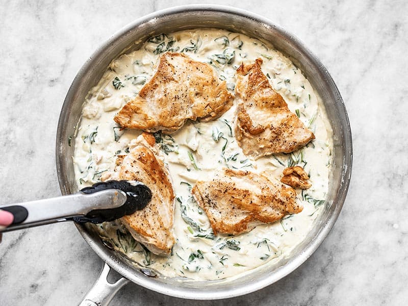 Return Chicken to the Skillet and spoon creamy spinach artichoke sauce over top
