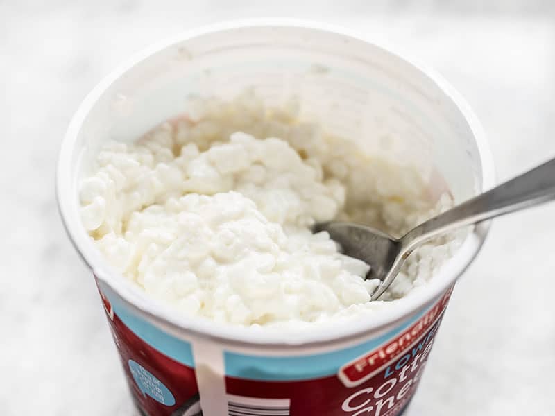 Cottage cheese container with a spoon in it