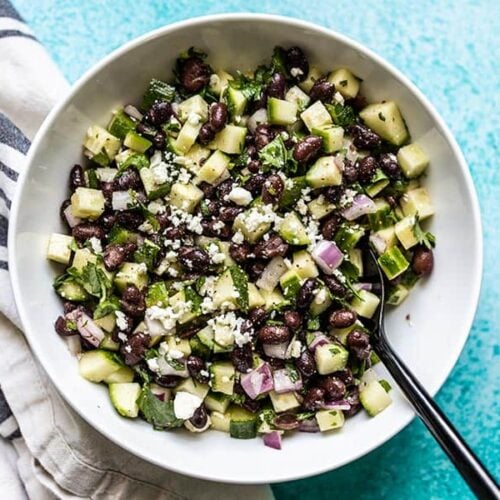 Cucumber and Black Bean Salad in a bowl with a black spoon
