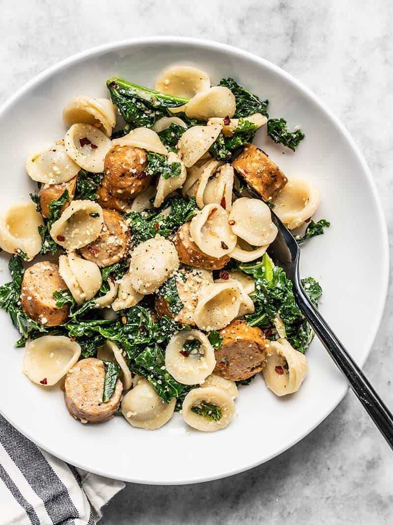 Overhead view of a shallow bowl full of Spicy Orecchiette with Chicken Sausage and Kale