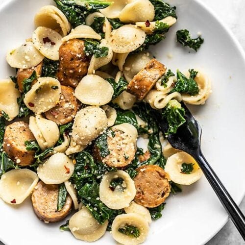Overhead view of a shallow bowl full of Spicy Orecchiette with Chicken Sausage and Kale