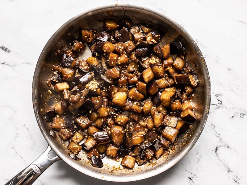 Soy glazed eggplant in the skillet just after cooking.