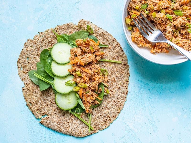 Tortilla filled with spinach, cucumber slices, and Sweet and Spicy Tuna Salad