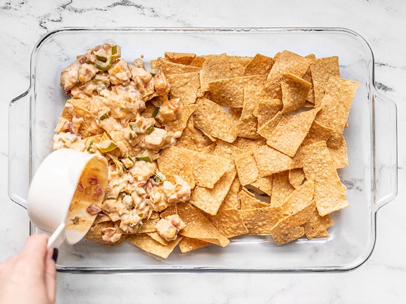 Layering tortilla chip strips and chicken mixture in casserole dish