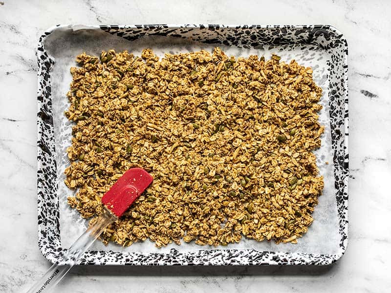 Oil Free Granola spread over the lined baking sheet.