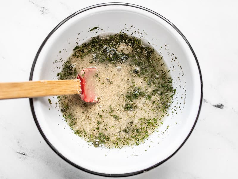 Half stirred Lemon Dill Tahini Dressing looking clumpy.