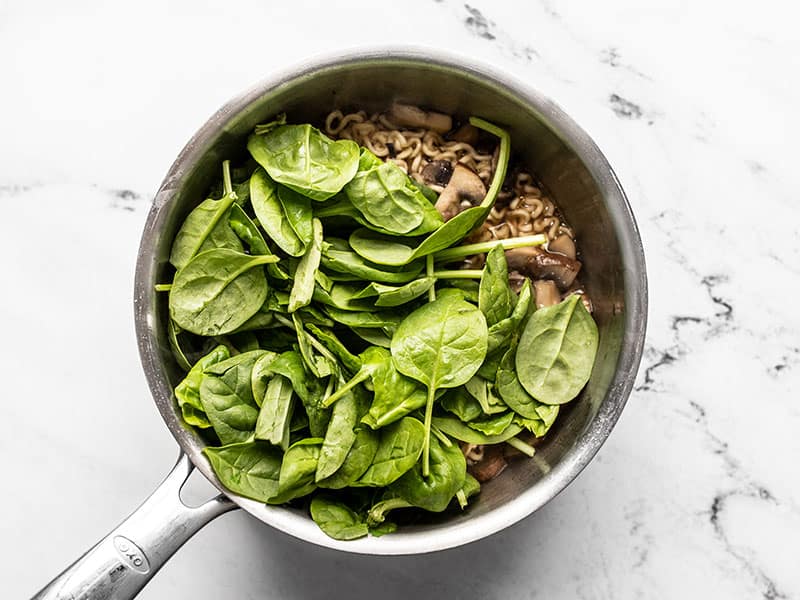 Spinach added to the sauce pot.