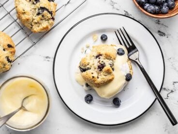 A Blueberry Lemon Curd Shortcake on a plate surrounded by the ingredients