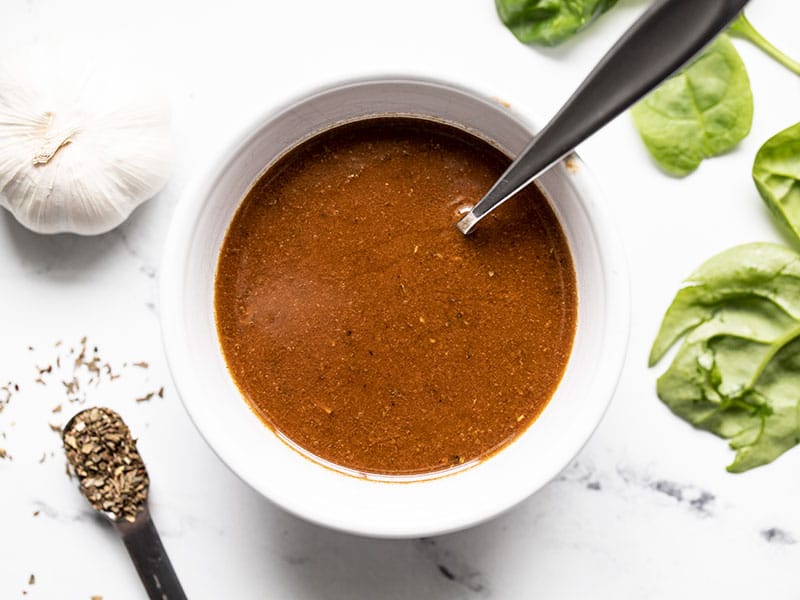 finished homemade balsamic vinaigrette in a small bowl with a spoon