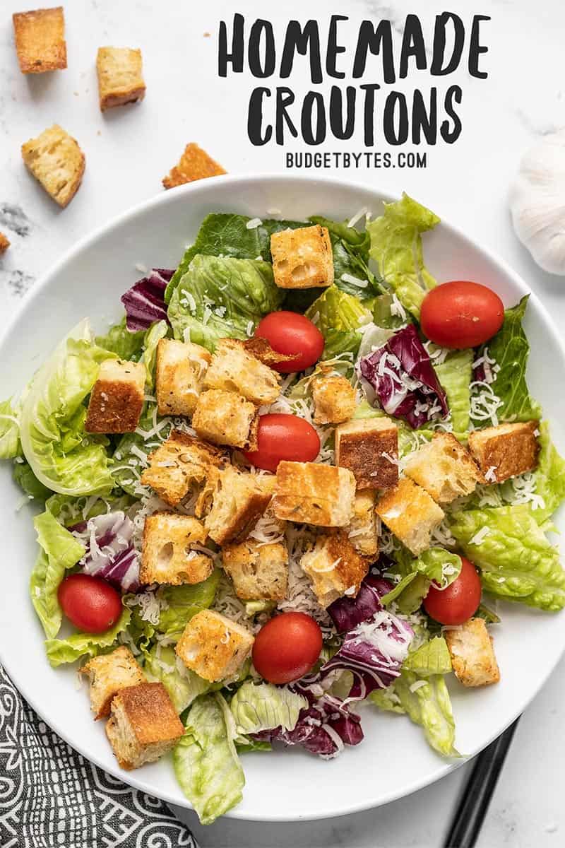 Overhead view of a large salad topped with homemade croutons