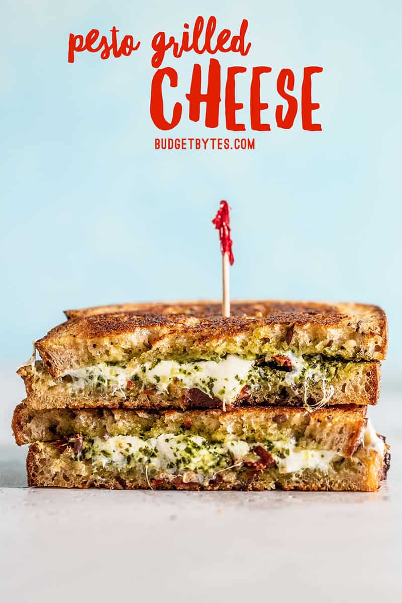 A stacked pesto grilled cheese against a blue background with title text at the top in red.