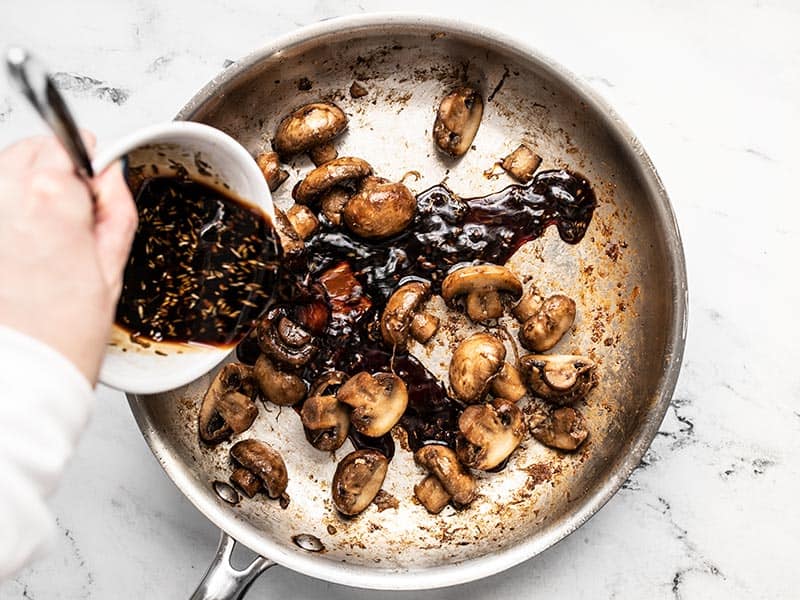 Balsamic sauce being poured into the skillet