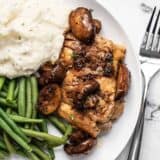 Close overhead view of Balsamic Chicken and Vegetables on a plate with mashed potatoes and green beans