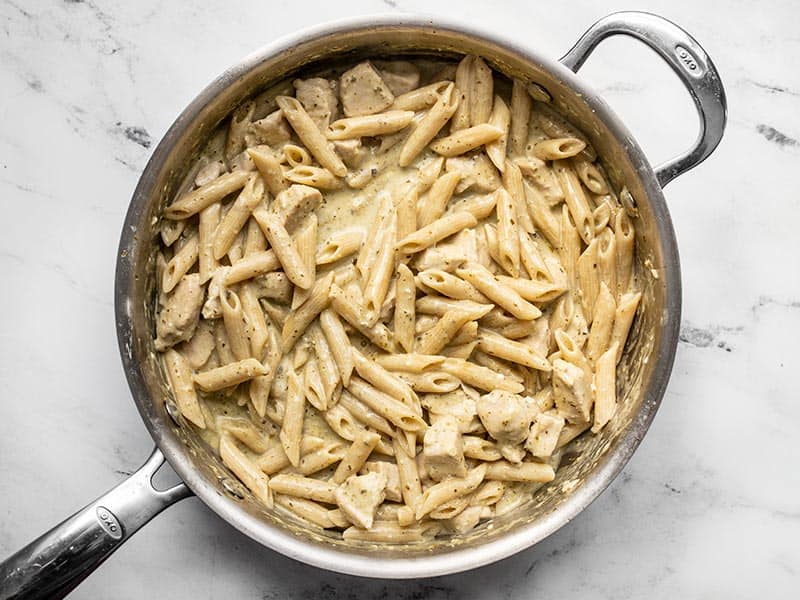 Finished creamy pesto pasta sauce and pasta in the skillet