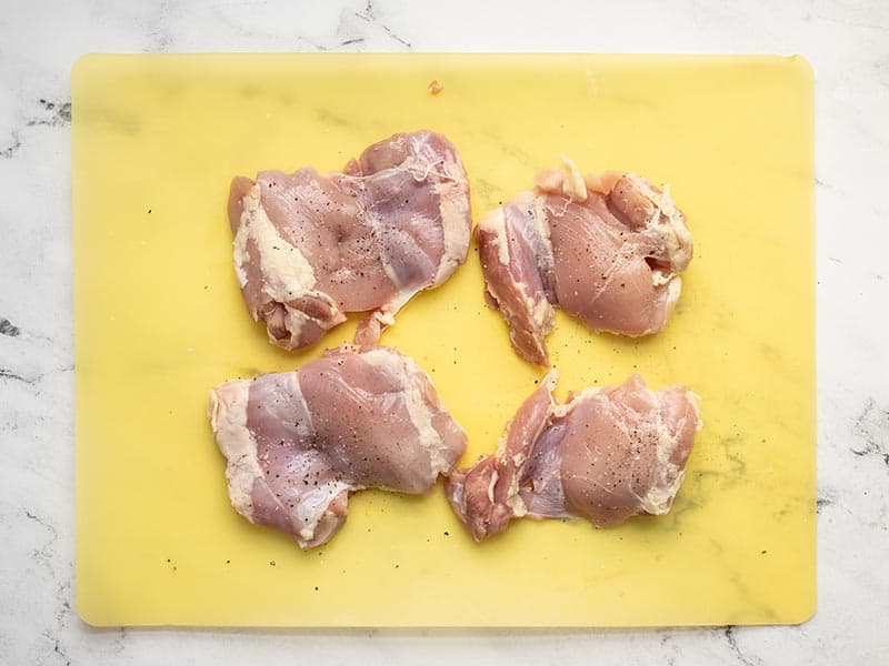 Season chicken thighs