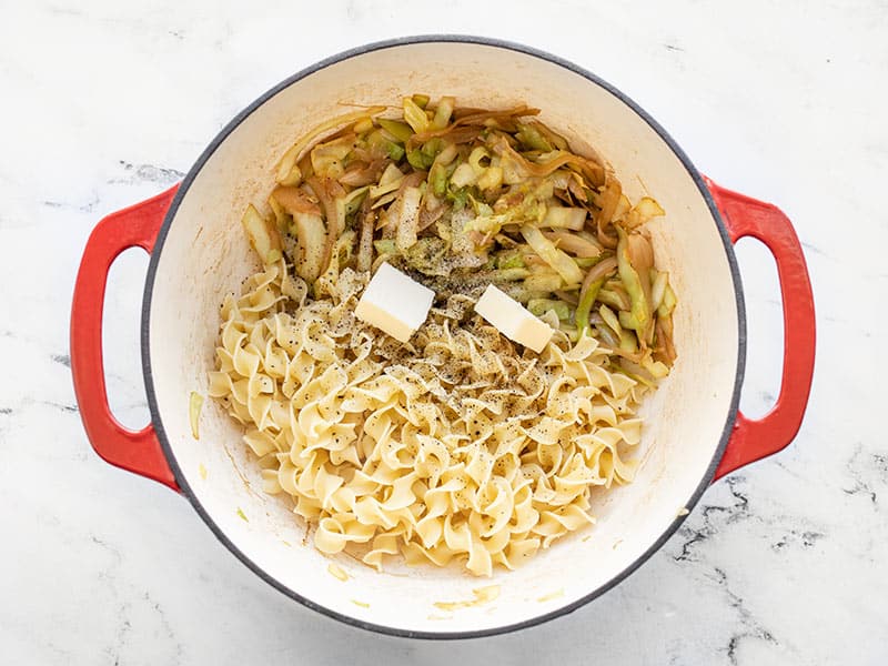 Cooked noodles, butter, and cabbage in the pot