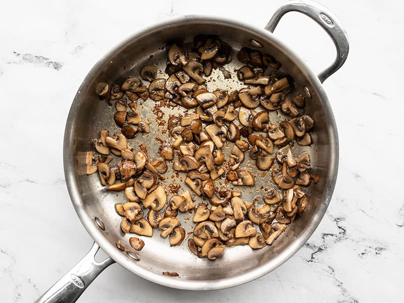 Sautéed and browned mushrooms in the skillet
