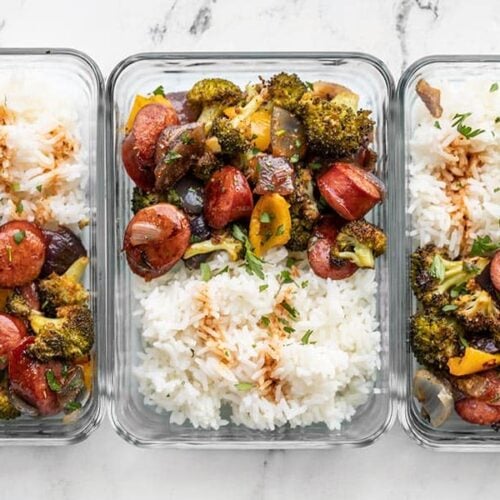 Three glass meal prep containers with rice and Smoky Roasted Sausage and Vegetables