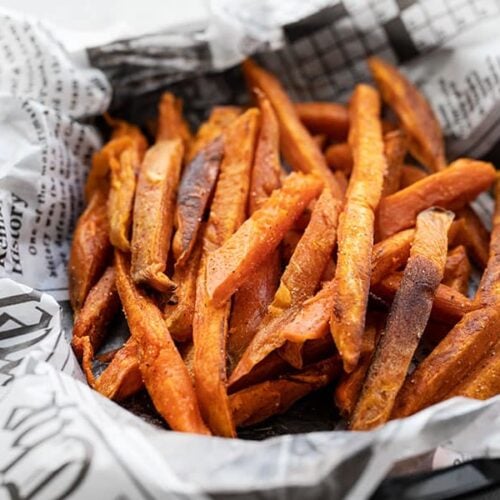 Close up side view of one bowl full of spicy sweet potato fries