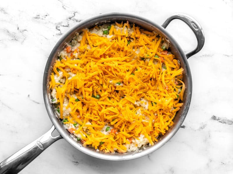 Shredded cheese added to the skillet