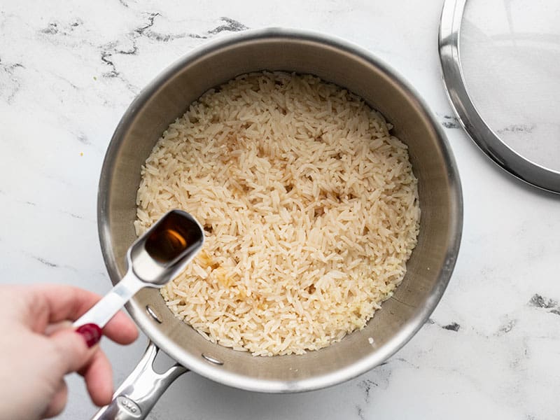 Add sesame oil to the cooked rice