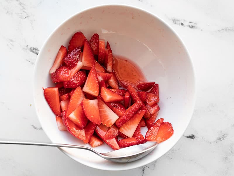 Juiced sliced strawberries in a bowl