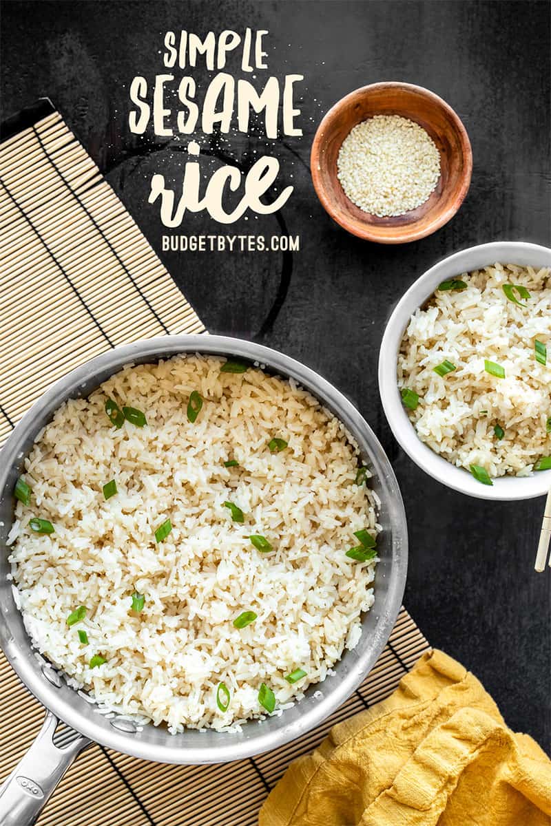 A pot and bowl of sesame rice together, garnished with green onions
