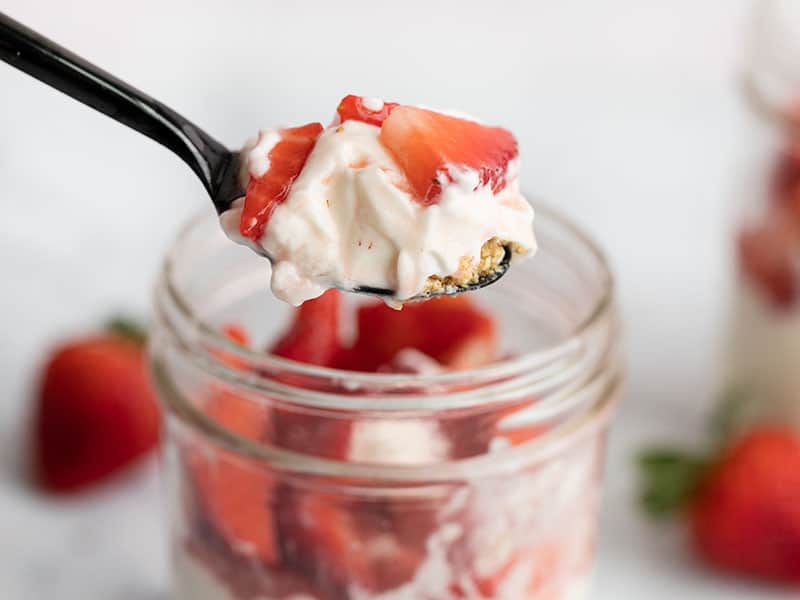 Close up of no bake strawberry cheesecake on a spoon