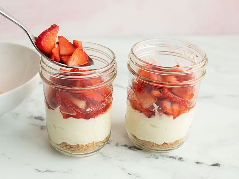 Add strawberries on top of the jars