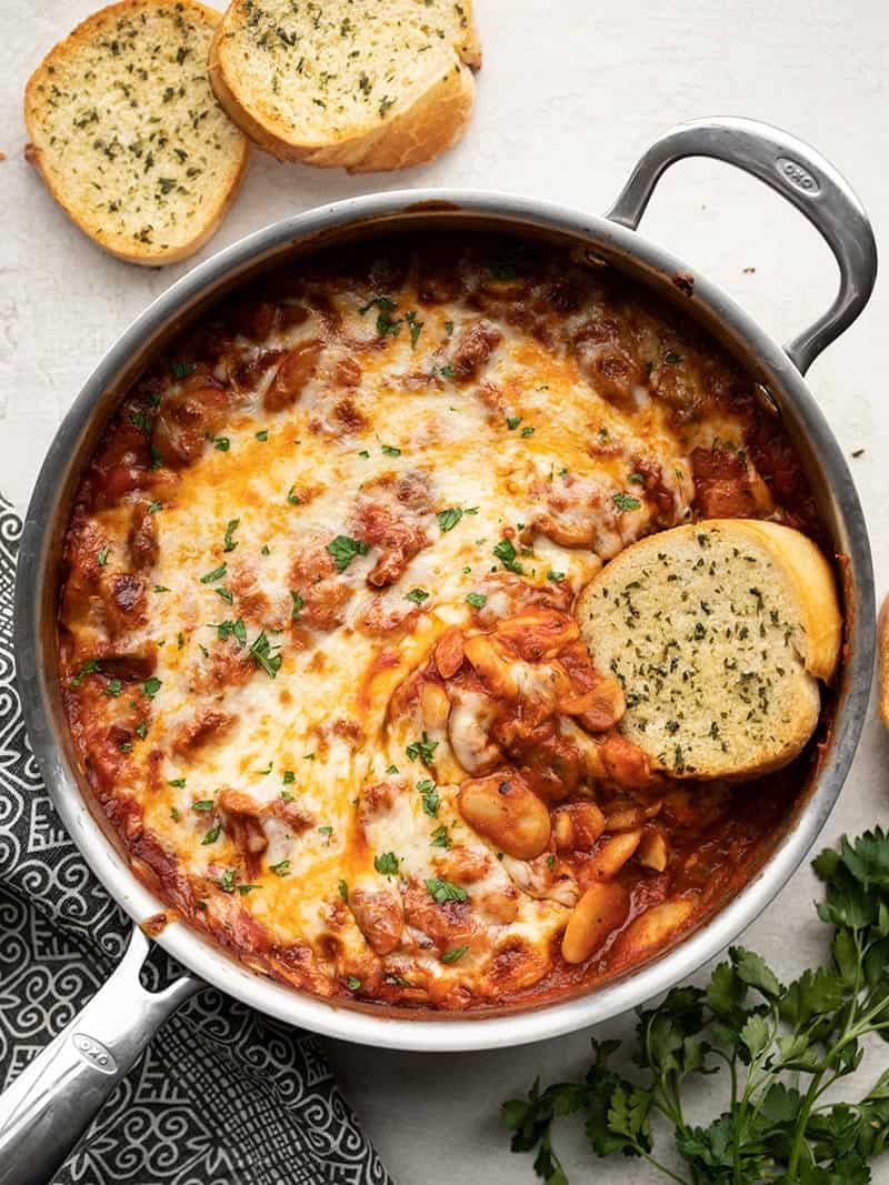 Finished White Beans with Mushrooms and Marinara, a piece of garlic bread dipped in the side