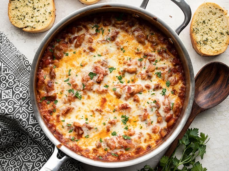 Overhead view of the baked skillet full of white beans with mushrooms and marinara