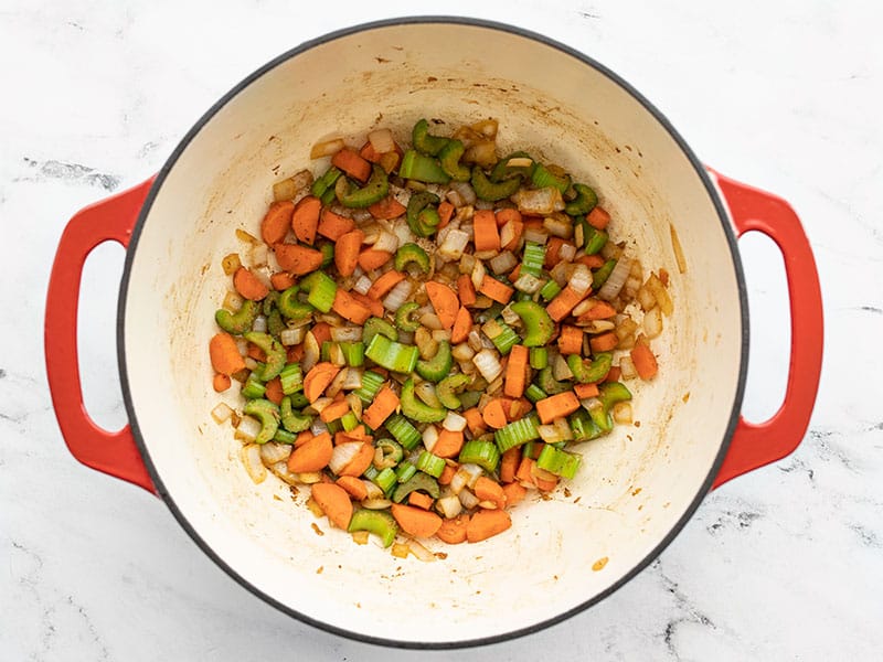 Diced vegetables cooked in soup pot.