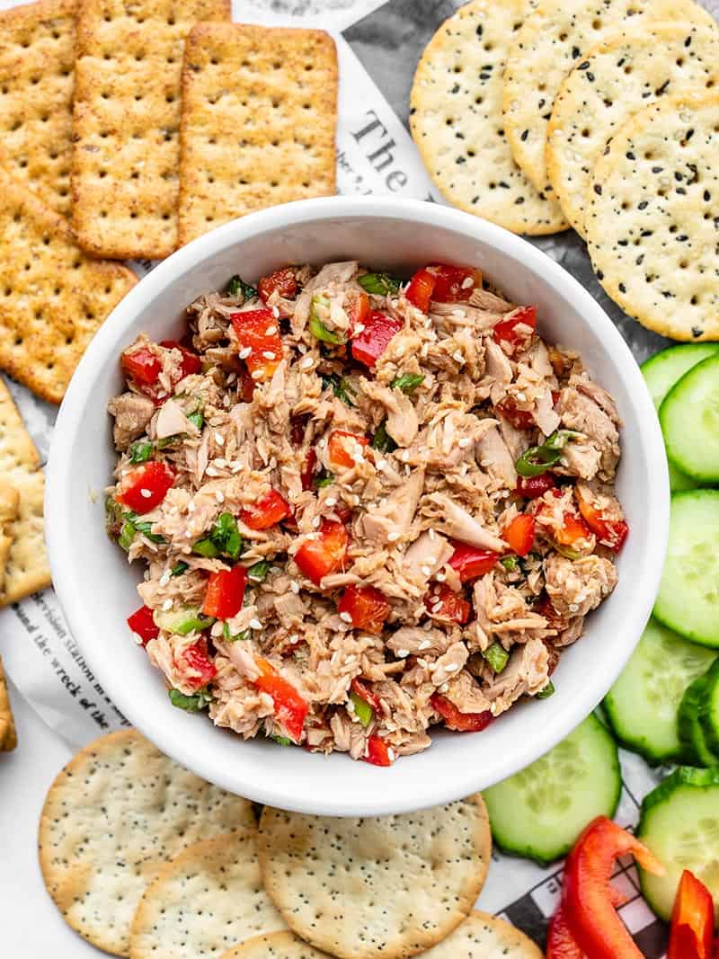 This fun spin on canned tuna is savory, sweet, and nutty. Sesame Tuna Salad is great on crackers, sliced cucumber, in lettuce wraps, or on salad greens. BudgetBytes.com A bowl of Sesame Tuna Salad surrounded by crackers, cucumber slices, and red pepper slices
