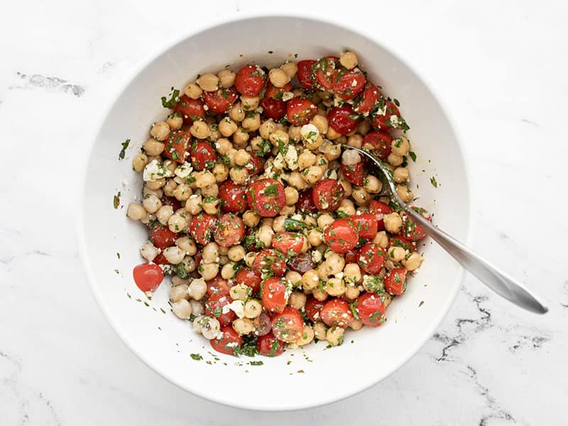 Finished chimichurri chickpea salad in a bowl with a spoon
