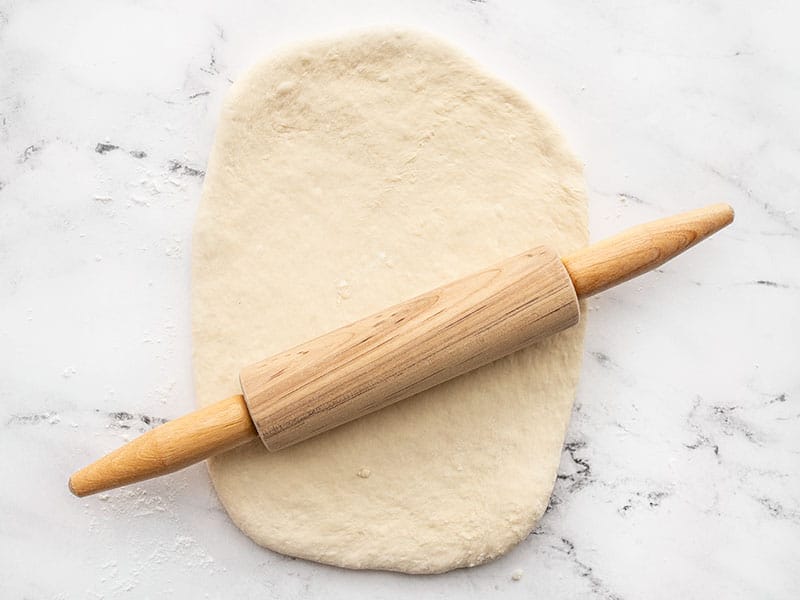 Dough being rolled out with a rolling pin