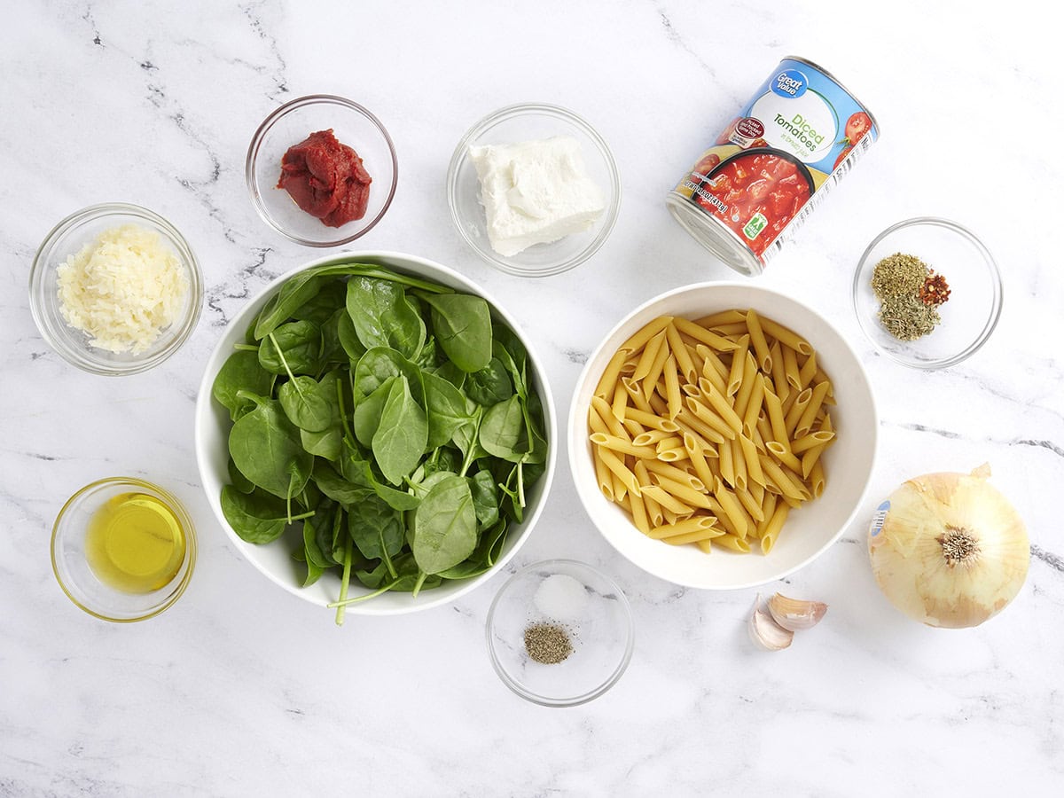 The ingredients to make creamy tomato spinach pasta.