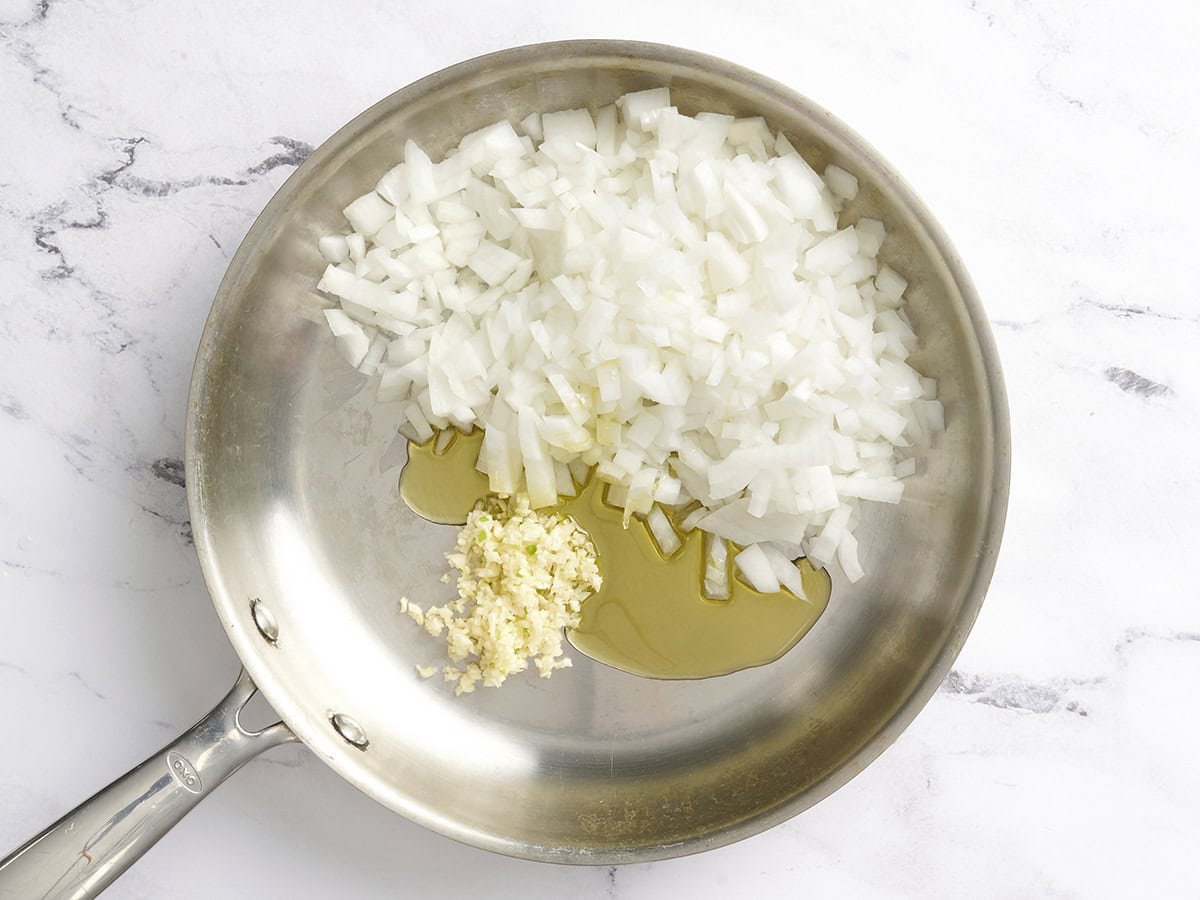Diced onion and minced garlic with oil in a skillet.
