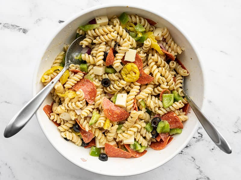 Tossed pizza pasta salad in a large bowl