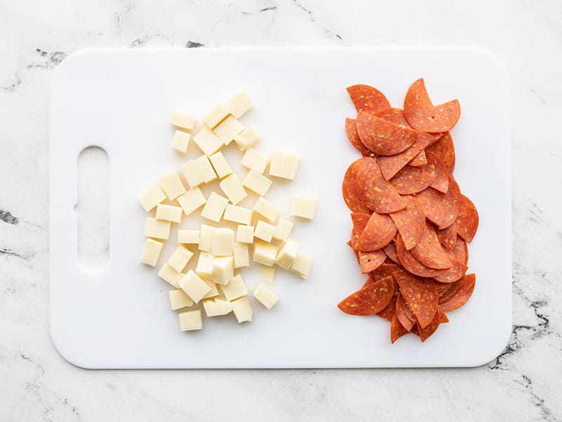 Mozzarella and pepperoni on a cutting board