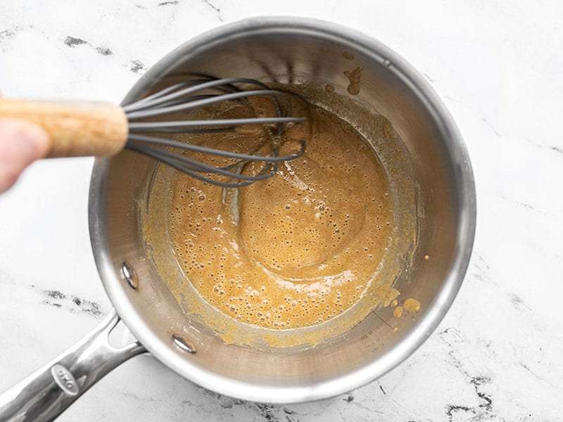 Oil, flour, and spices being cooked in the sauce pot