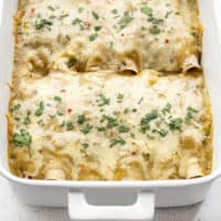 front view of green chile chicken enchiladas in the casserole dish