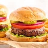 Side view of a black bean burger in a hamburger bun with toppings.
