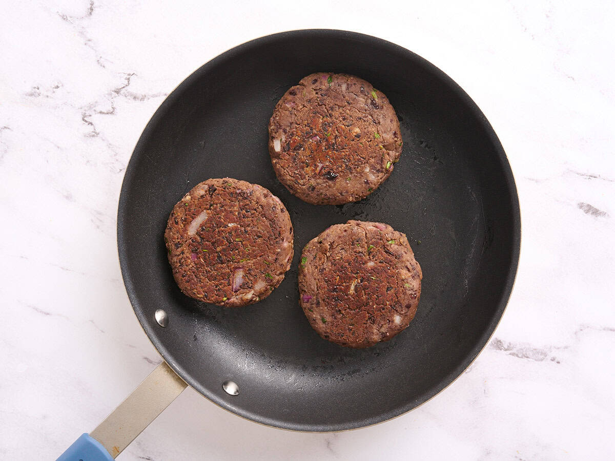 Black bean burgers in a skillet.