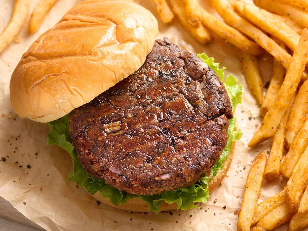 Overhead view of a black bean burger with the top bun removed.