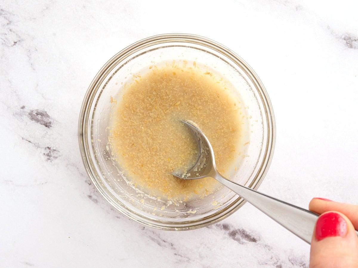 Flax seed and hot water being in a bowl.