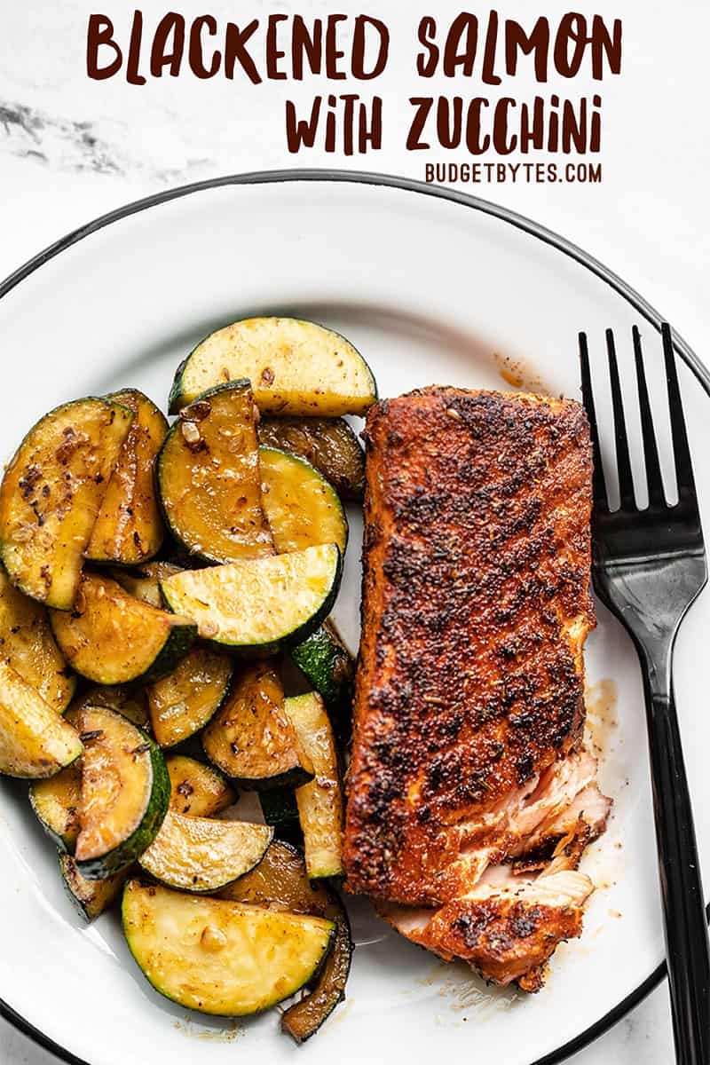 Blackened salmon on a plate with zucchini and a black fork, title text at the top
