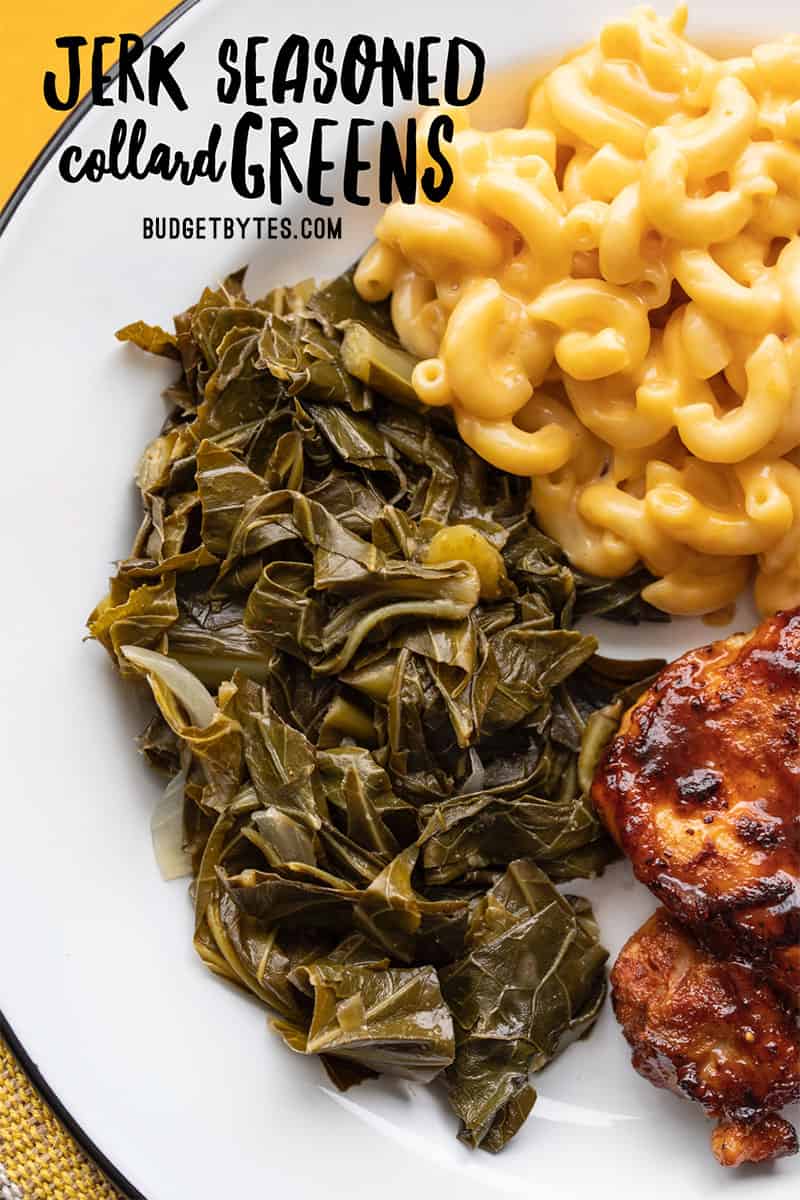 Jerk seasoned collard greens on a plate with mac and cheese and bbq chicken
