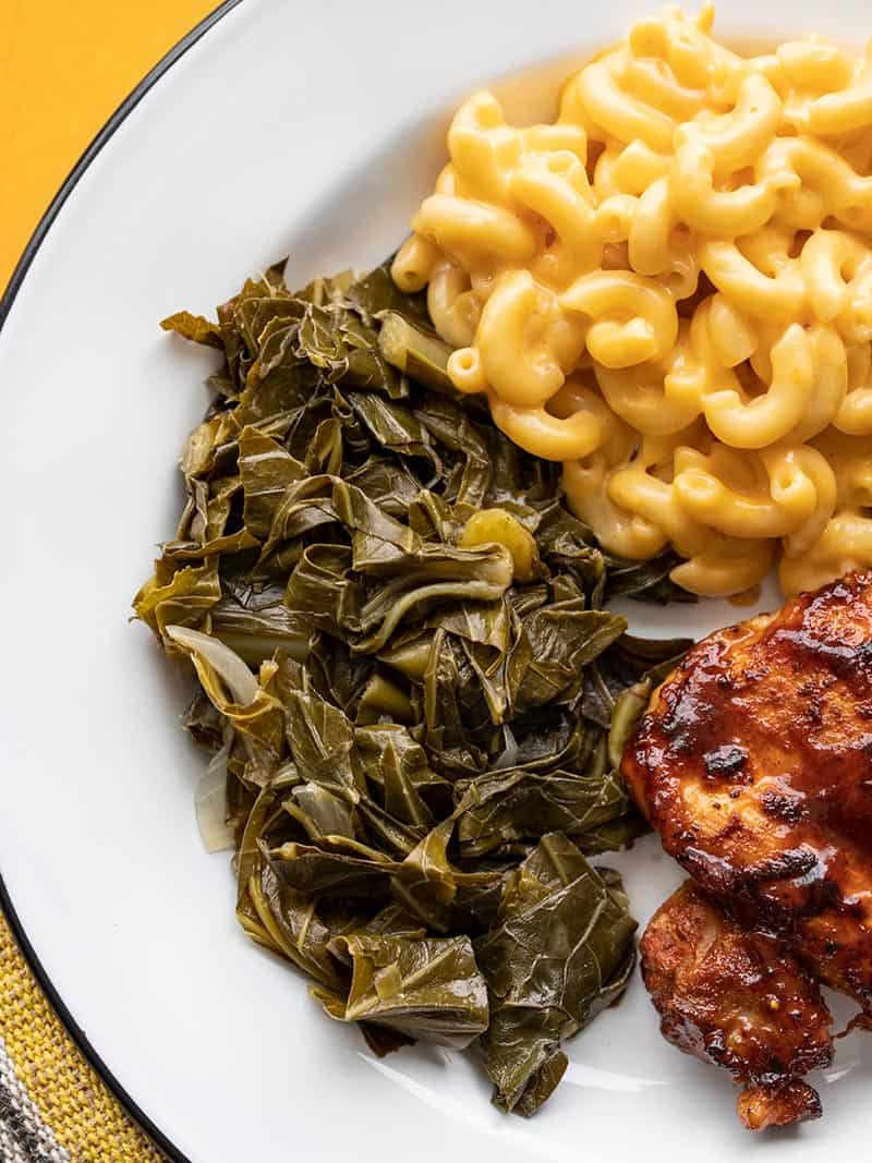 Collard Greens on a plate with Mac and Cheese and BBQ Chicken