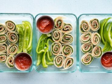 Three pizza roll up lunch boxes lined up in a row